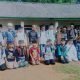 Peserta didik perdana Madrasah Asbabul U'lum, Desa Gunung Sugih Besar, sumringah foto bersama dengan latar belakang gedung sekolah yang memprihatinkan, karena Belum pernah ada perbaikan selama puluhan tahun, Kamis (12/11/2020) - foto Dok
